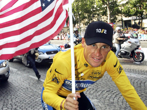 Lance Armstrong cycles down the Champ-Elysees for the parade after the podium ceremony for the 21st and final stage of stage of the 92nd Tour de France cycling race between Corbeil-Essonnes and Paris, in this July 24, 2005 file photo (Credit: Reuters / Stefano Rellandini)