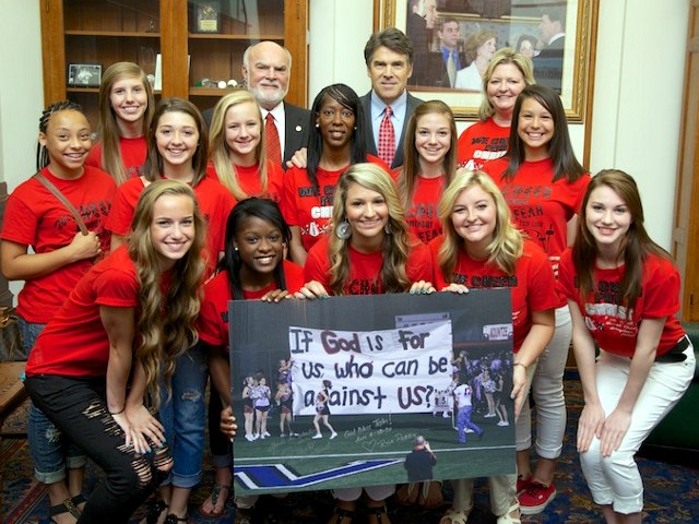 Texas Governor Rick Perry poses for a photo with the Kountze High School cheerleaders at the signing of House Bill 308, which allows public school students and staff to use traditional holiday greetings and display religious scenes and symbols on school property (Credit: Office of the Governor Rick Perry)