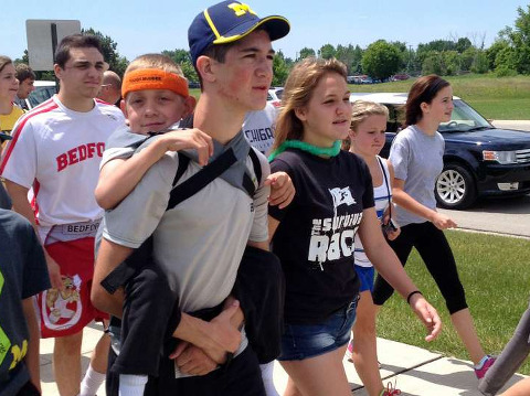 Hunter Gandee, 14, walks in Saline, Michigan, on Sunday with his 7-year-old brother, Braden (Credit: CBS)