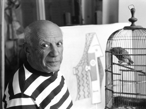 Pablo Picasso poses for a photo near a birdcage at his home, the Villa La Californie in Cannes, 1957 (Credit: René Burri)