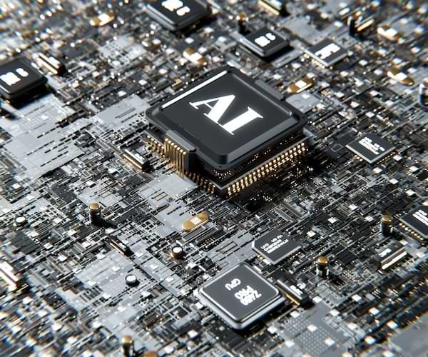 A computer motherboard with a chip in the middle and the initials "AI' stamped on top