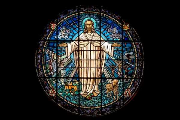 Stained glass image of the resurrected Christ with arms open