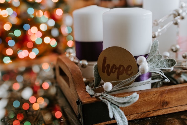 Christmas decor with candles and the word "hope" on display
