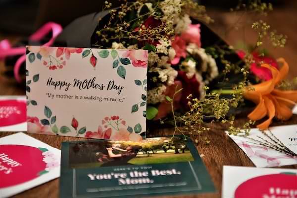 Mother's Day cards and flowers arranged on a table