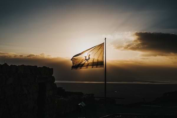 Israeli flag flying at dusk