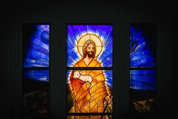 Stained glass depicting the risen Christ holding a lamb
