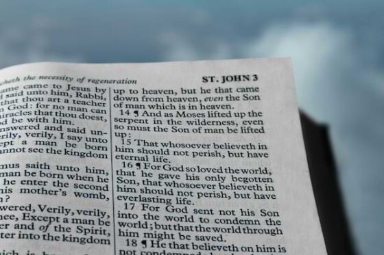 A Holy Bible open to John 3:16 - "For God so loved the world...."