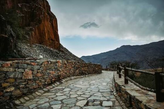 Ancient stone pathway curving around the base of a mountain