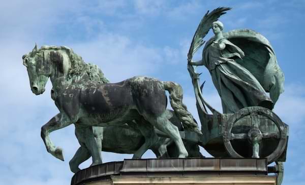 An ancient sculpture of a horse and chariot