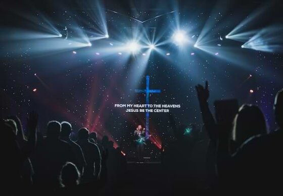 people-standing-on-stage-with-lights, worshiping Jesus